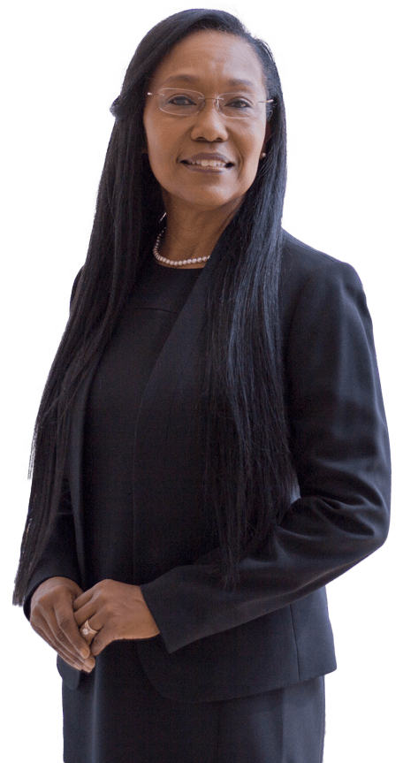 Confident professional woman in a black suit and glasses, smiling warmly. This image represents leadership and professionalism in corporate settings.
